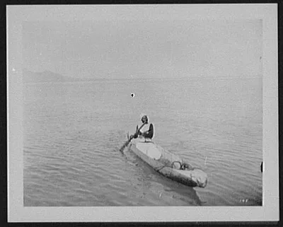 Suez - a Sudanese in a dugout canoe, Egypt, 1894
