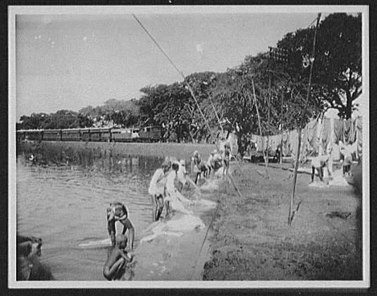 Colombo - natives washing clothes at water's edge; railway train in…, Sri Lanka, Colombo, 1895