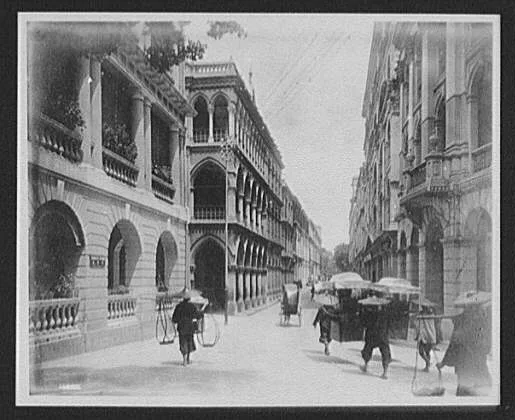 Looking down street of European buildings, China, 1895