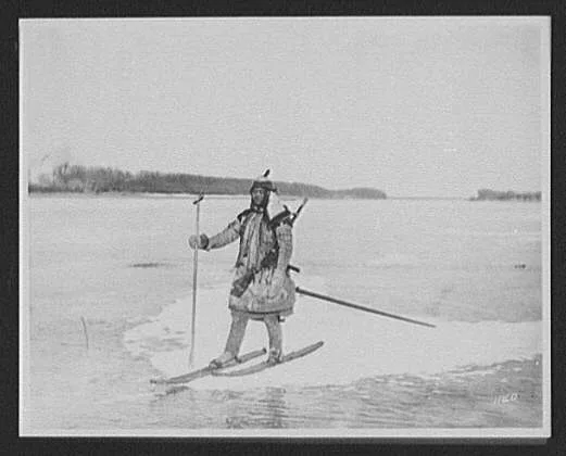 Goldes hunter on skis on ice floe, with spear and rifle, Russia, 1895