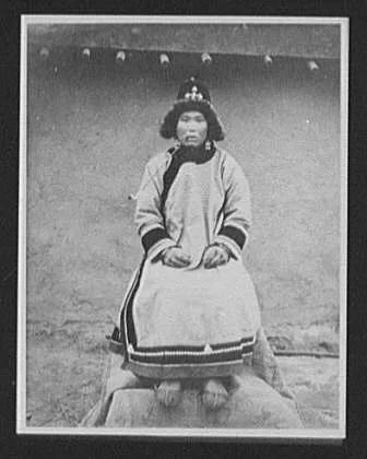 Goldes woman, wife of village chief, smoking pipe, Russia, 1895