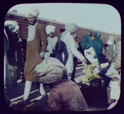Indians buying food from vendor at railway station, 1895