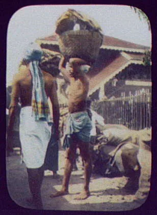 Man carrying large loaded basket on his head, India, 1895