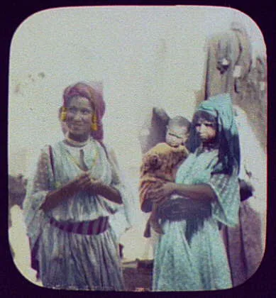Smiling woman and woman holding baby, India, 1895