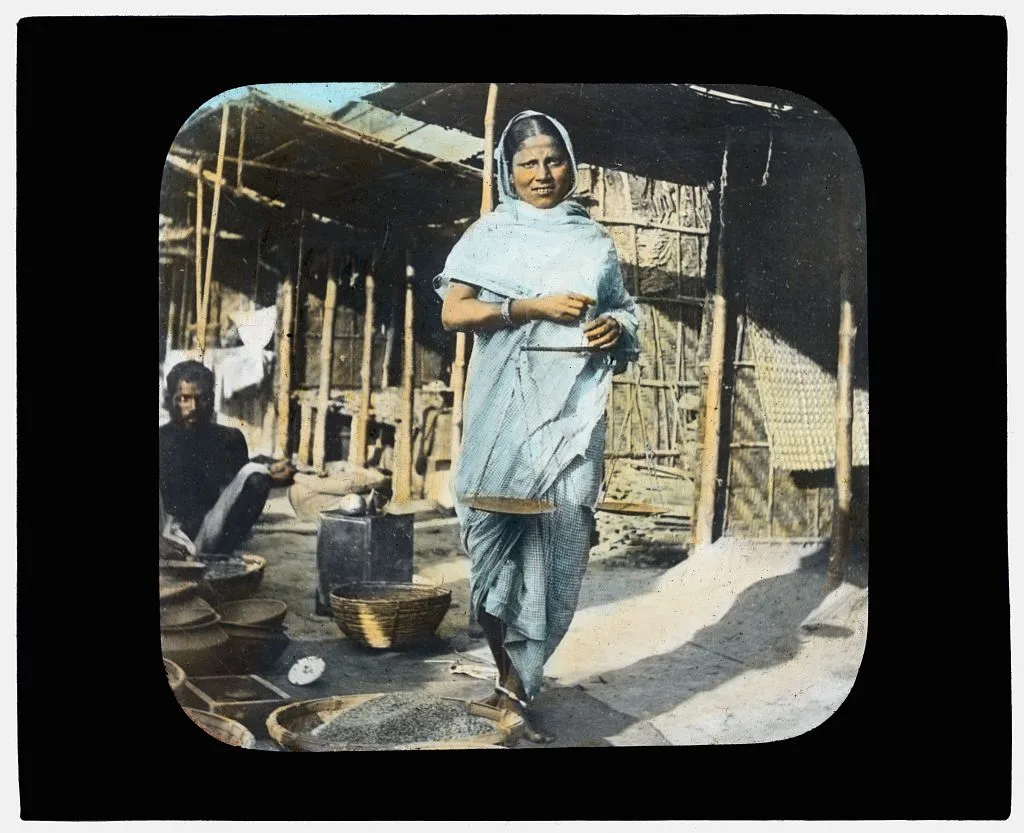 Young woman street vendor holding measuring scales, India, 1895