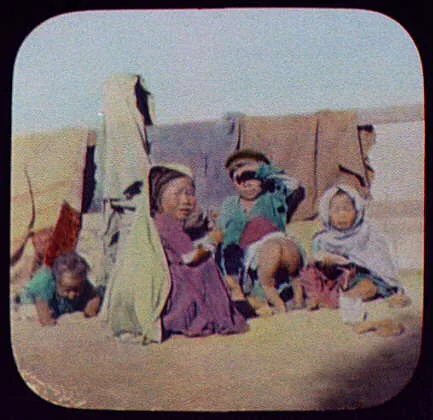 Indian children - 5 small children in front of fence draped with…, 1895