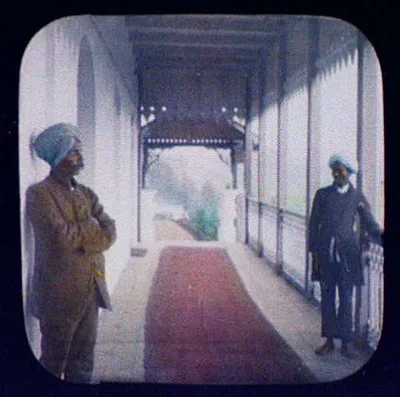 Jacob and Andy; two turbanned men standing in red-carpeted hallway, India, 1895