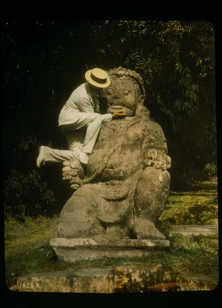Man in straw hat standing on Buddhist idol at ruins of Borobudur, Java, Indonesia, Borobudur, 1895