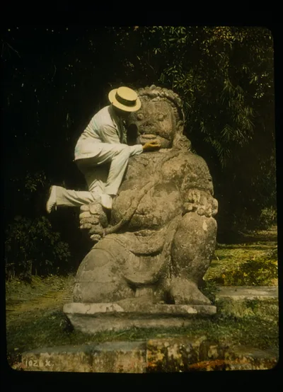 Man in straw hat standing on Buddhist idol at ruins of Borobudur, Java, Indonesia, Borobudur, 1895