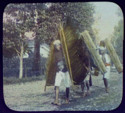 Three men carrying palm leaf and matting rain shields, Java, Indonesia, 1895