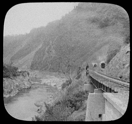 Train leaving tunnel along Manawatu Gorge, New Zealand, Manawatu River, 1895