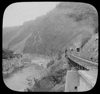Train leaving tunnel along Manawatu Gorge, New Zealand, Manawatu River, 1895