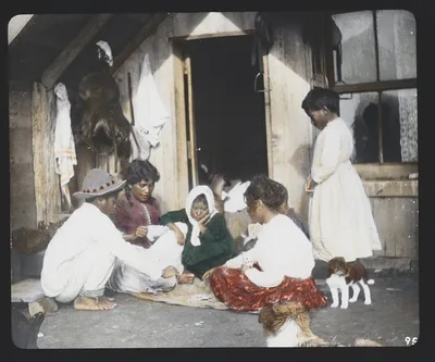 Maori woman and children playing cards on doorstep of home -…, New Zealand, 1895