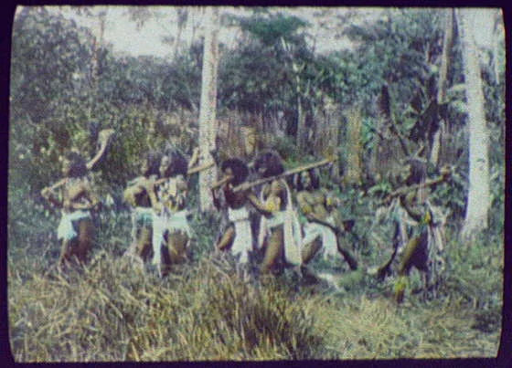 Seven warriors in jungle, two dragging dead (?) body, Oceania, 1895