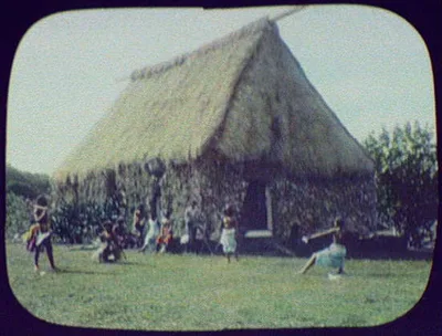 Natives in front of large thatch-roofed building, Fiji, 1895