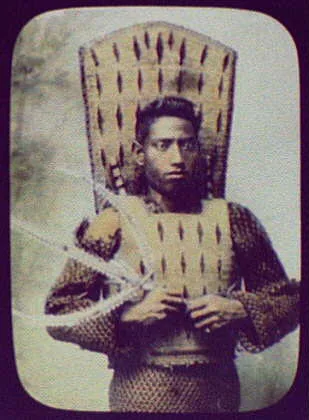 Warrior in ceremonial armor, holding triton, Oceania, 1895