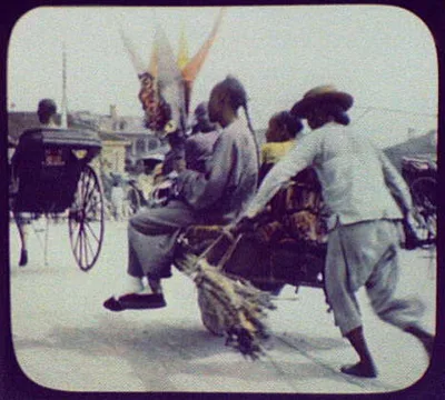 Three men seated in wheelbarrow pushed by man, China, 1895