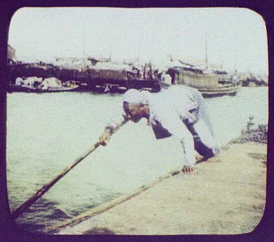 Raftsman using pole on river boat, China, 1895