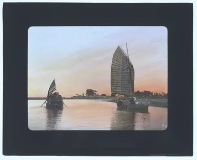 Sunset on river; houseboat flying large U.S. flag, China, 1895