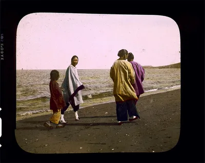 Four women walking along sea-shore, China, 1895