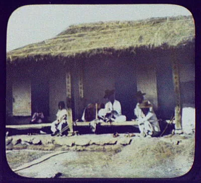 Men and children sitting on porch of house, Korea, 1895