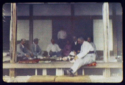 WTC [i.e. World Transportation Commission] dining on porch of building, Japan, 1895