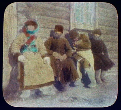 Four convicts sitting against house, Siberia, 1895