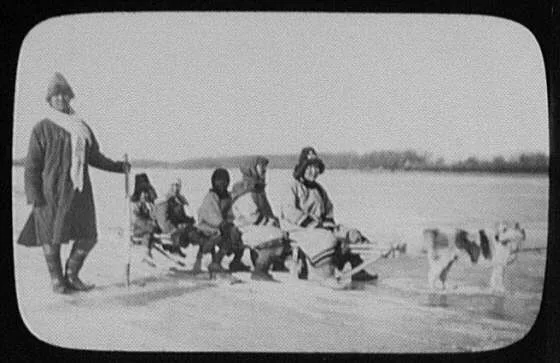 Man standing beside 5 Goldi women and children on dog sledge, Russia, China, Amur River, 1895