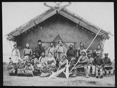 Goldi villagers posed in front of building with fishing catch - on…, Siberia, 1895