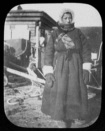 Man (Yemschik?) standing at Siberian post house, 1896
