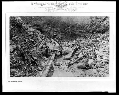 Photograph from 1872: [Three men in gulch with a sluice, placer mining…
