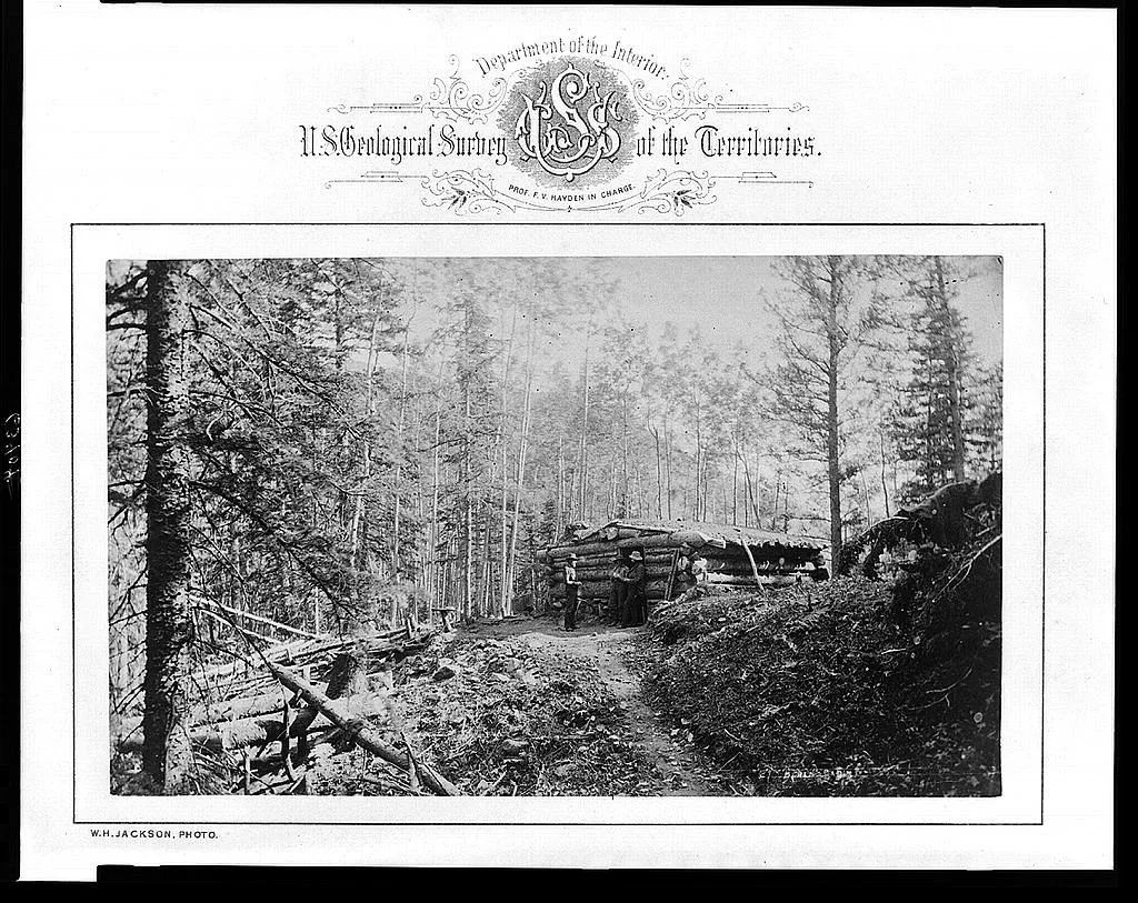 [Three men standing in front of log cabin at camp for U.S. Geological…, Rocky Mountains, 1872